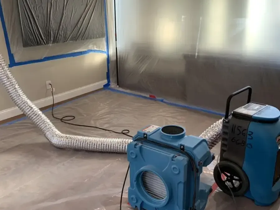 Plastic containment and a dehumidifier running during a dry-out