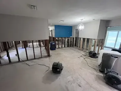 Flood-cut walls and air movers drying an open living area