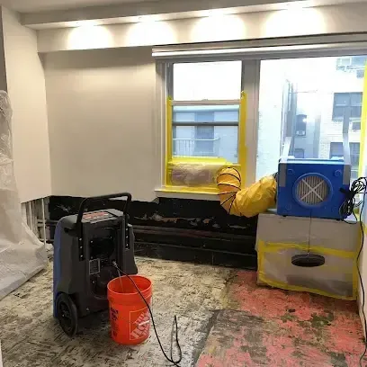 Dehumidifier and air mover drying a room with flooring removed, Somerdale dry-out example