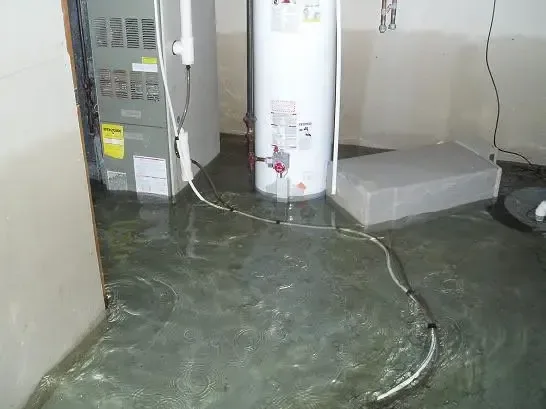 Water spread across a basement utility room after the sump pump quit
